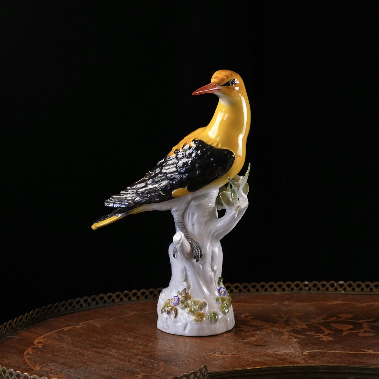 Antique Meissen porcelain Golden Oriole figurine, male bird with yellow body and black wings perched on a flowering tree stump, model 820