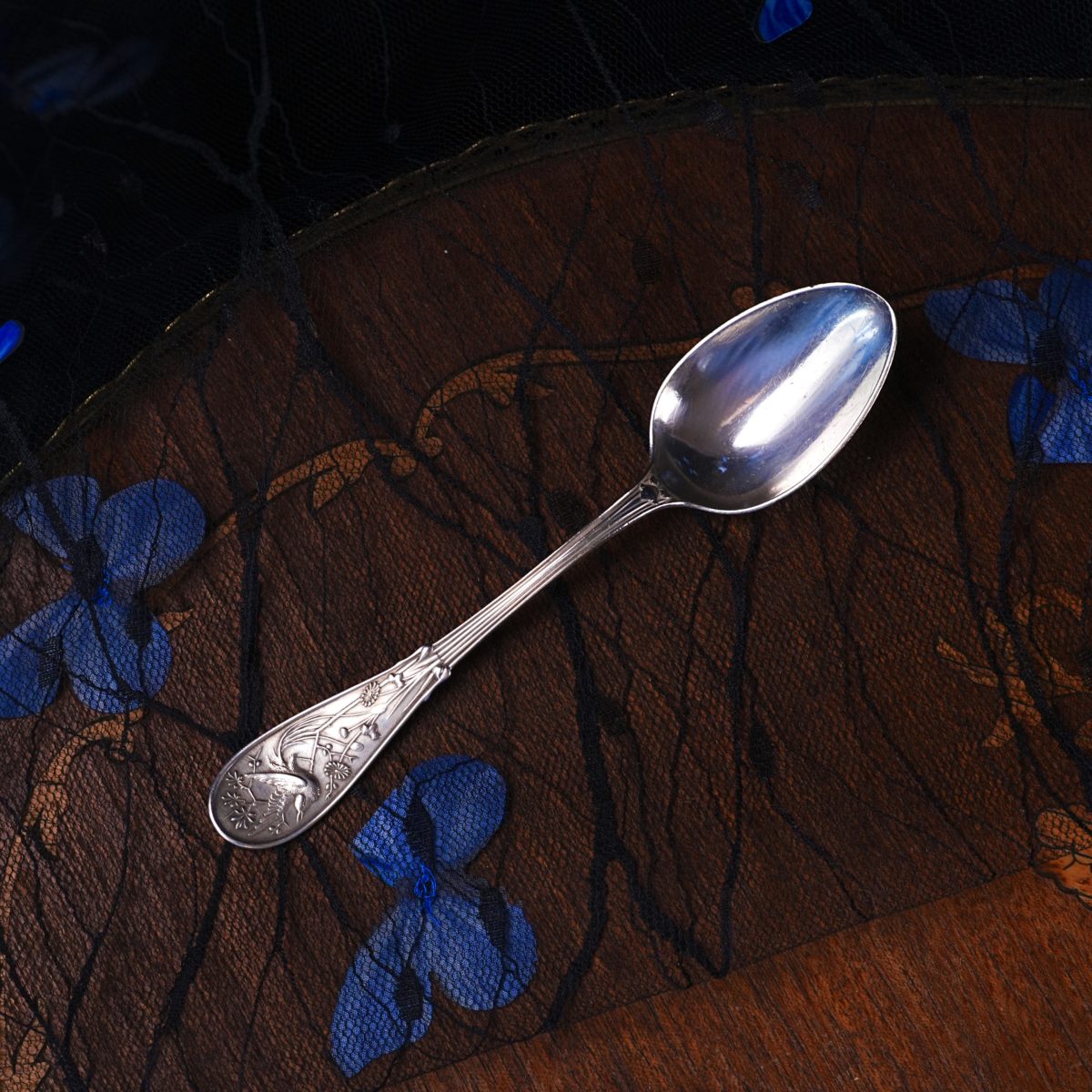 Antique Tiffany & Co. sterling silver teaspoon in the Japanese (Audubon) pattern, plain oval bowl and a handle cast in relief with a wading bird among blossoms